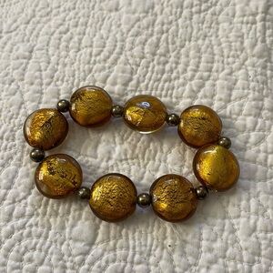 Bracelet, gold toned crackled beads. Expandable.